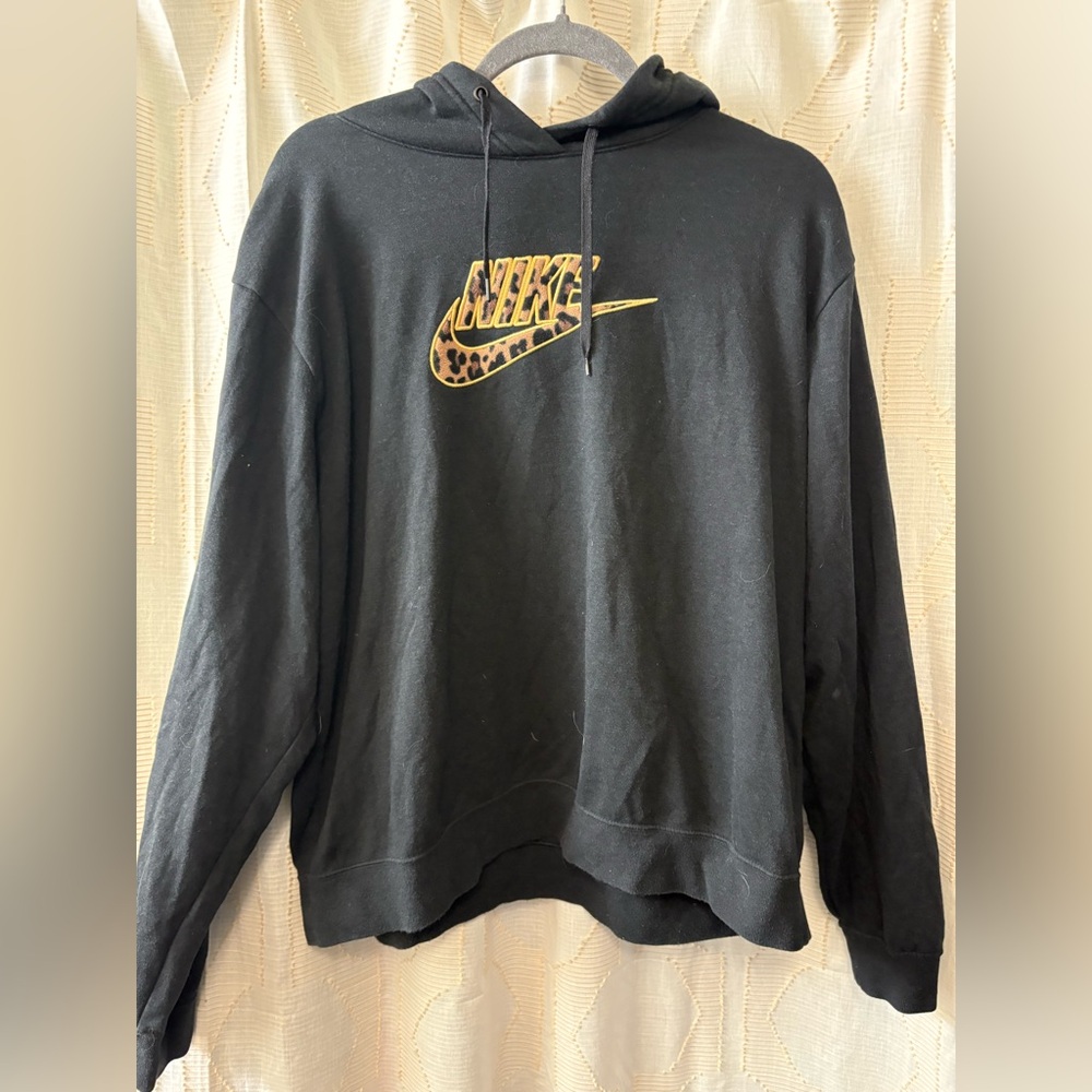 Women’s size large black Nike hoodie with cheetah print symbol